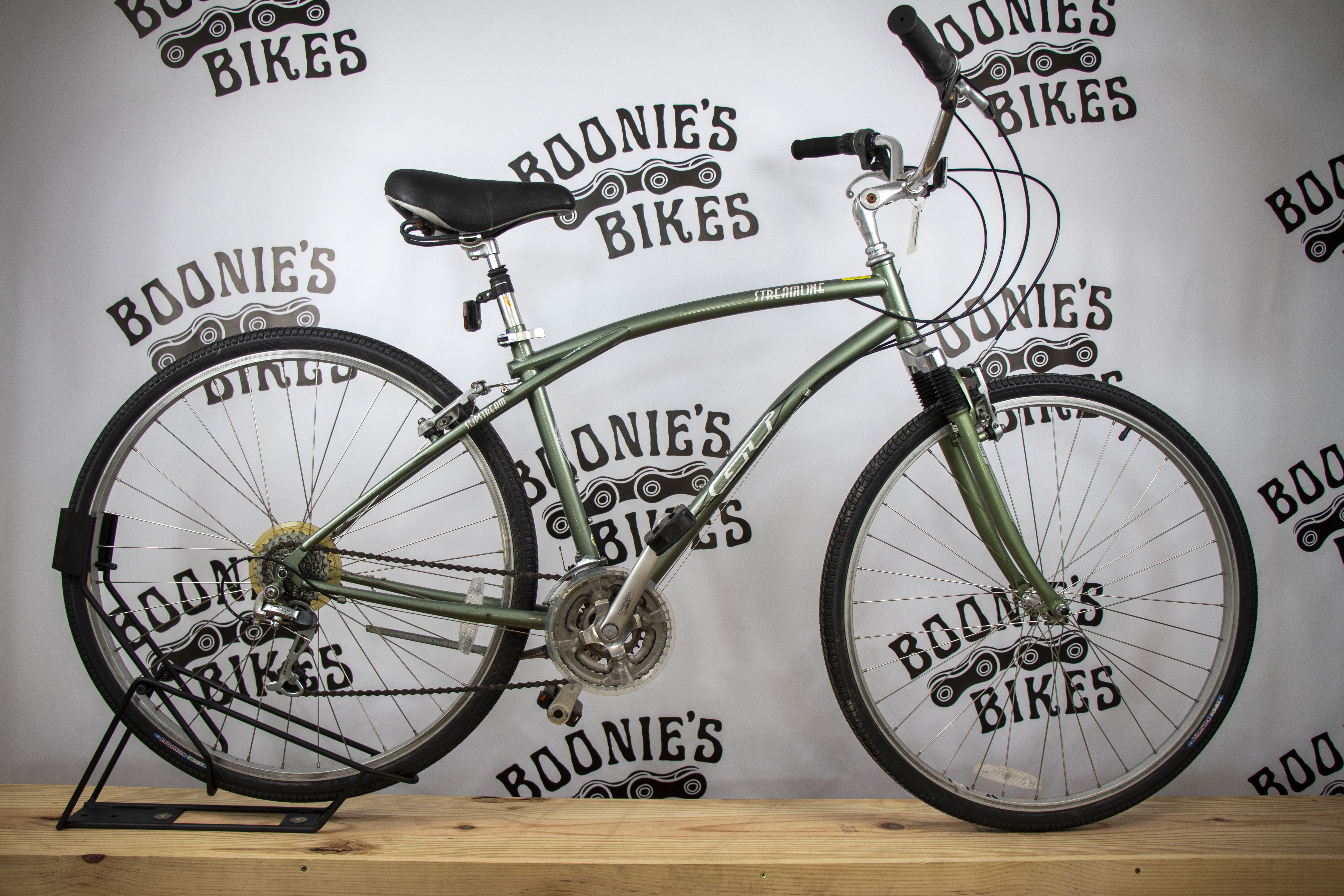 Green bicycle on a stand with 'Boonie's Bikes' branding in the background