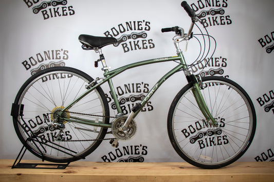 Green bicycle on a stand with 'Boonie's Bikes' branding in the background